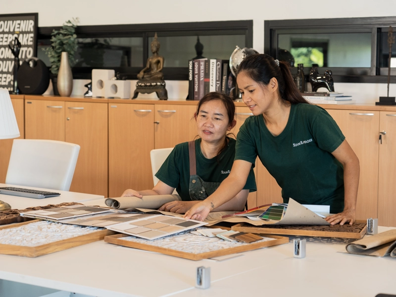 Siam Sawadee artisans reviewing custom headboard designs in Chiang Mai