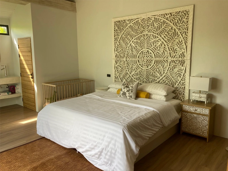 arved teak headboard with matching nightstands in a serene bedroom