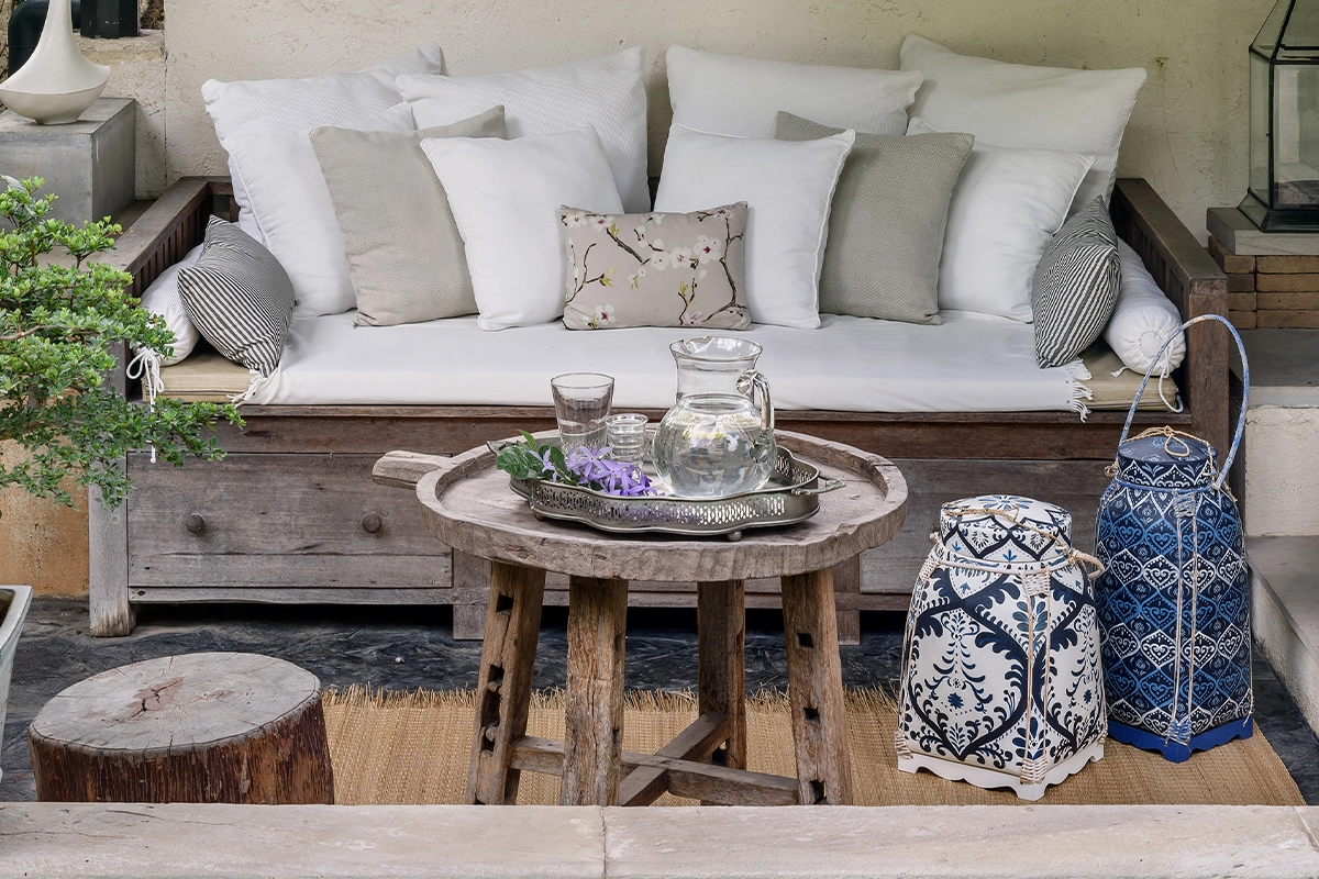 Handwoven bamboo baskets from Thailand styled as decorative accents beside rustic wooden furniture.