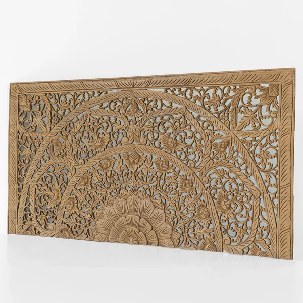 Angled view of hand-carved reclaimed teak headboard featuring floral and mandala patterns.