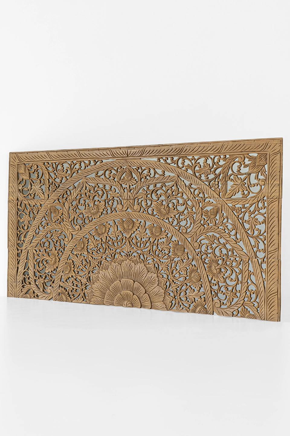Hand-carved-half-headboard-in-california-king-brown-stain-2 Angled view of hand-carved reclaimed teak headboard featuring floral and mandala patterns.
