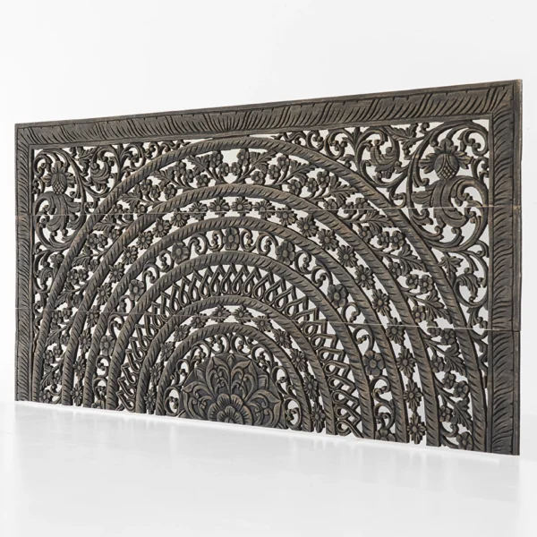 Angled view of rustic black Moroccan-style reclaimed teak headboard.
